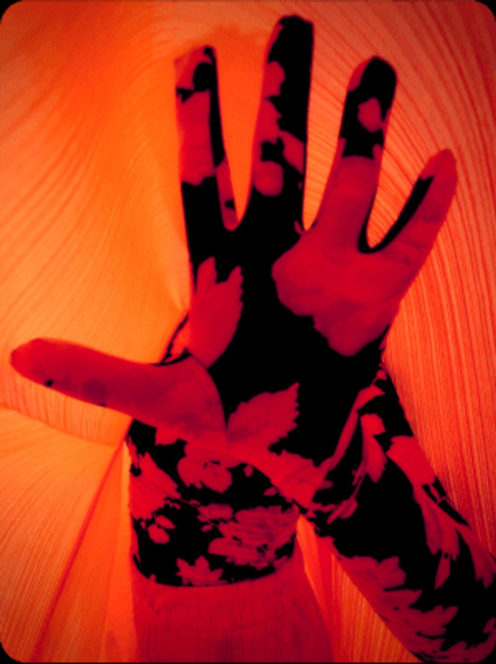 Hand facing the camera with bold style